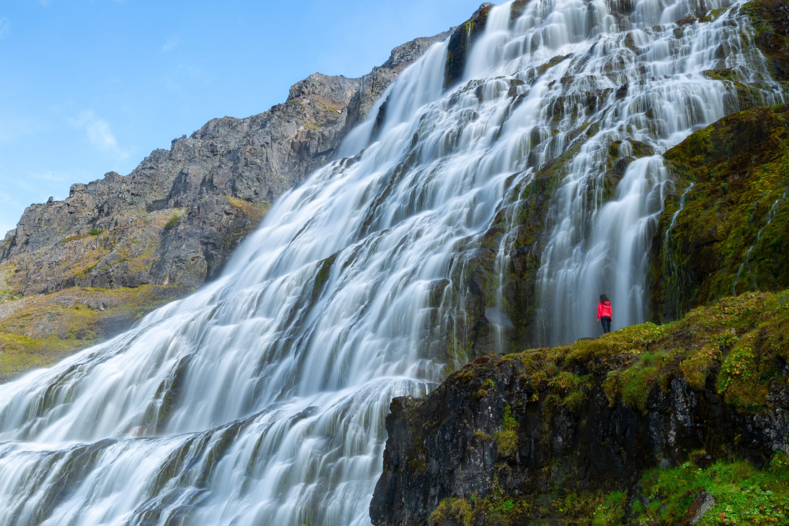 Person,Standing,In,Front,Of,The,Magnificent,Dynjandi,Waterfall,At